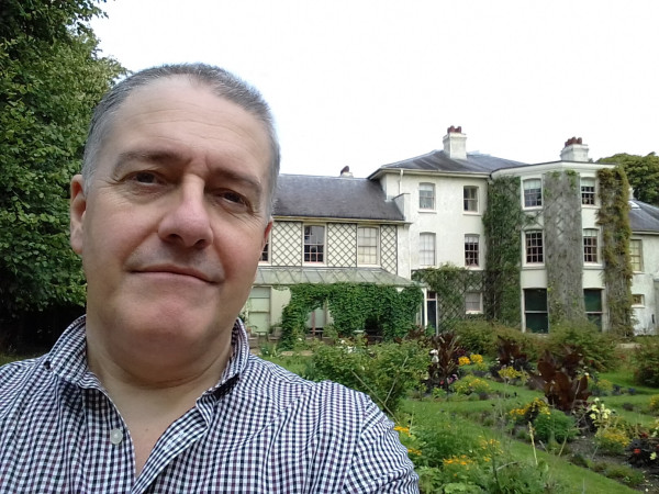 Photograph of myself in checked shirt outside Down House.