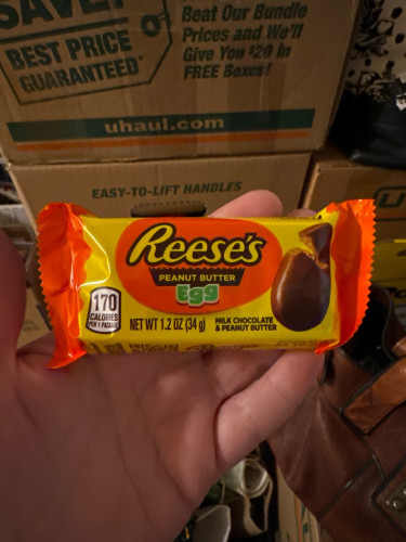 Wrapped Reese’s peanut butter egg in front of boxes