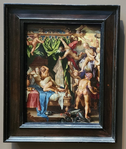 Oil on copper painting in a Renaissance style of a nude man and woman mid-copulation in bed, looking up, startled by various god, goddess and cherub figures, who are intruding from a bright light in the sky. 