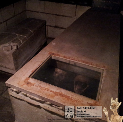 The picture shows a coffin with a glass window in which two skulls can be seen
