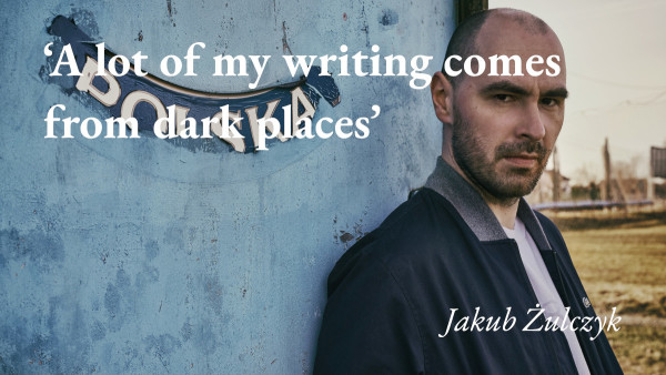 A portrait of the writer Jakub Żulczyk, with a quote from his podcast interview: 'A lot of my writing comes from dark places'