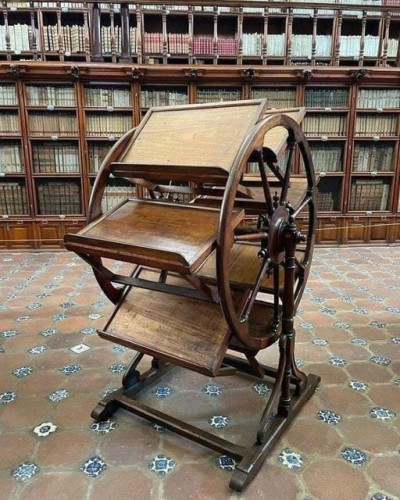 A medieval book wheel. A device for holding many books open at the same time, and turning them so any given pair of books can be referenced simultaneously. Commonly used for research projects where scholars would cross-reference different texts.