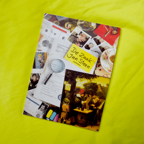 A book laying on a lime green sheet. The cover shows various disorganised objects such as a magnifying glass, photographs, a case file, finger prints, a police ID and a picture of a painting. The title is "The Jan Steen Case".