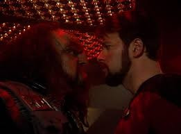 Riker facing Captain Kargan, a Klingon in an angry manner