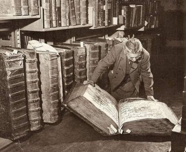 A woman reading through the The Codex Gigas ("Giant Book"; Czech: Obří kniha). This is the largest extant medieval illuminated manuscript in the world, at a length of 92 cm (36 in). Very large illuminated bibles were typical of Romanesque monastic book production, but even among these, the page-size of the Codex Gigas is exceptional.