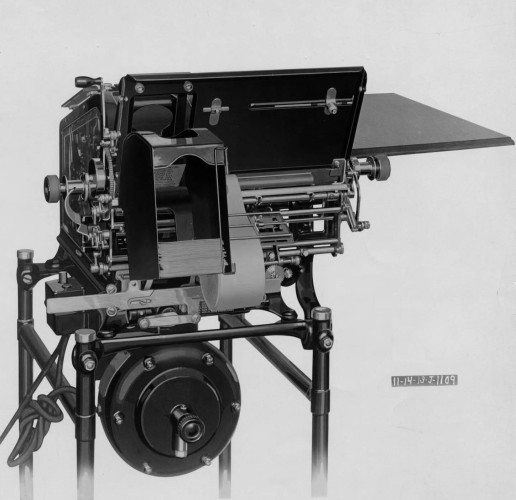 Black and white rendering of a "Pay Envelope Machine" of the Burroughs Corporation in 1913. The bar stands the printing carriage, envelope holder and gearing is all visible, a view from behind.